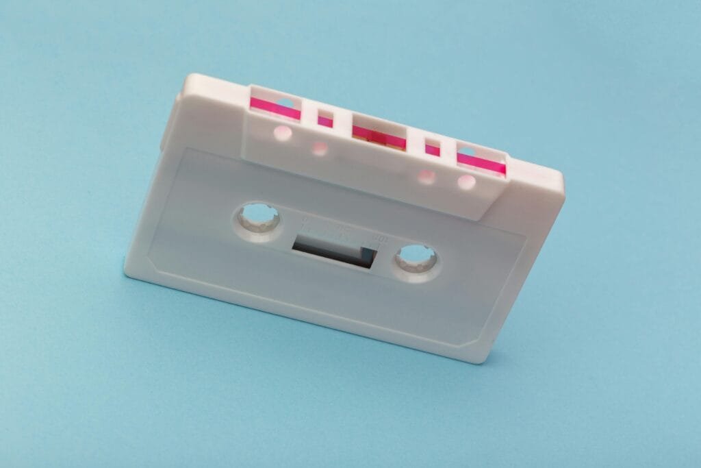 Top 20 Music Distributions Worldwide 1 Vintage white cassette tape against a vibrant blue backdrop, capturing classic audio technology nostalgia.